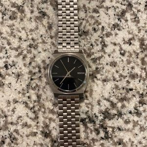 Men’s silver and black Nixon time teller watch